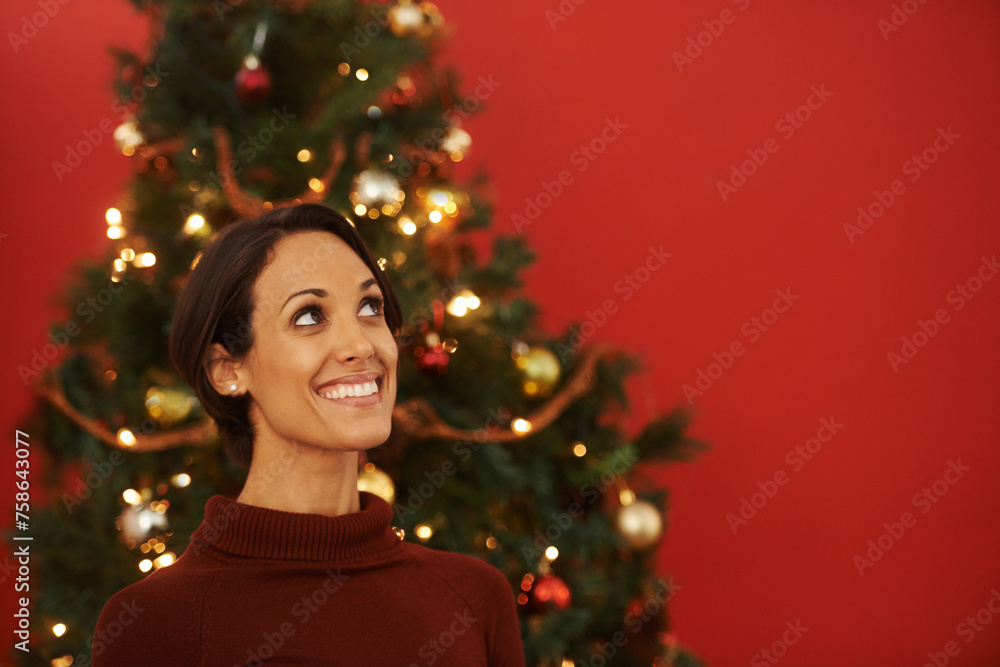 Christmas, thinking and woman in home with tree for festive holiday and planning decoration on vacation. Happy, girl or excited for xmas in winter and idea for house on red background in mockup space