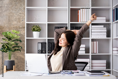 Young woman of working age, feeling various feelings that occur in the office, happy, stressed, relaxed in the company on a desk with equipment. Electronics are placed