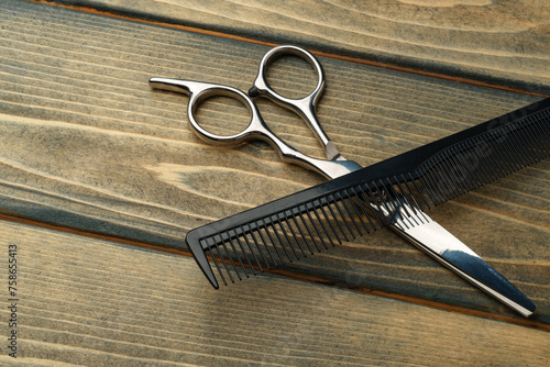 Hairdressing professional scissors on wooden background close up photo