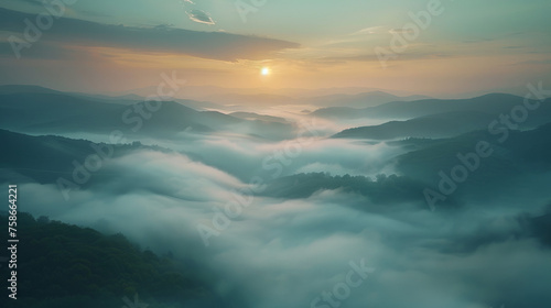 A serene landscape captures rolling hills enveloped in a blanket of soft mist under a tranquil dawn sky. The sun, breaking through the haze, offers a gentle glow