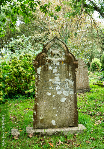 Alter verwitterter Grabstein hinter einer alten Kirche in Cornwall 