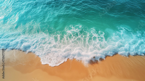 Aerial view of turquoise waves crashing on sunny sandy beach