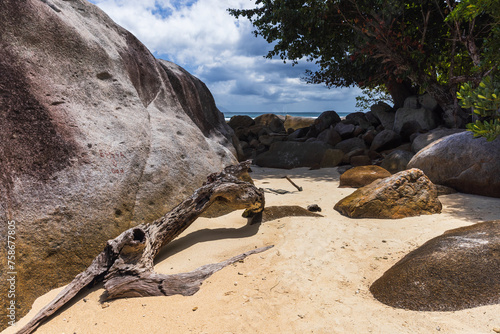 Coastal rocks lay on white sands of Beau Vallon beach, Seychelles