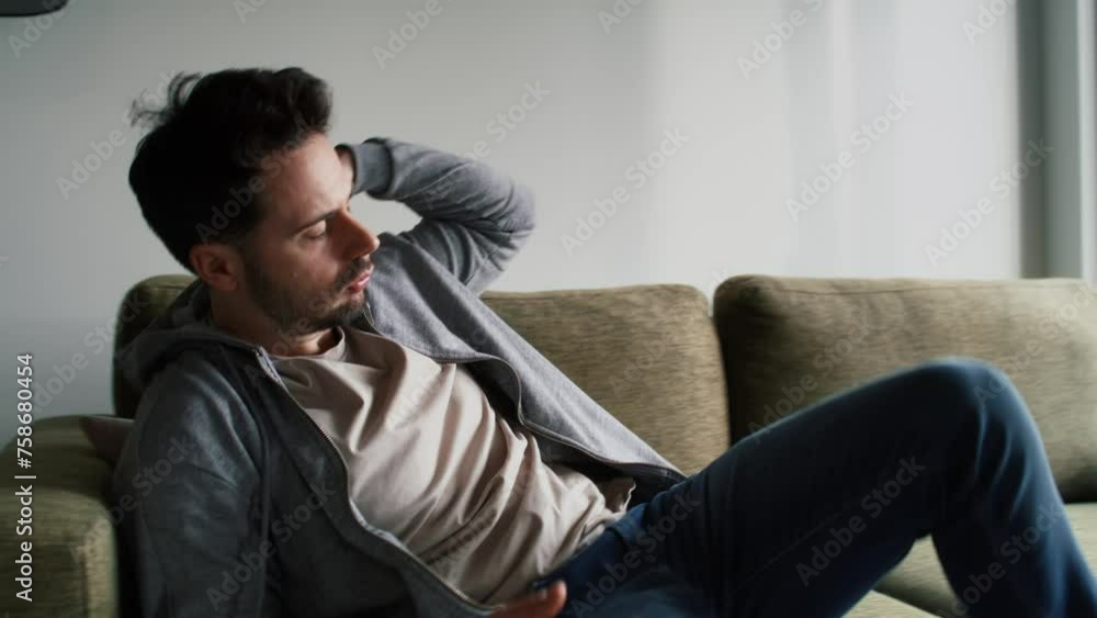 Thoughtful and anxious man at home on sofa Thoughtful and anxious man at home on sofa