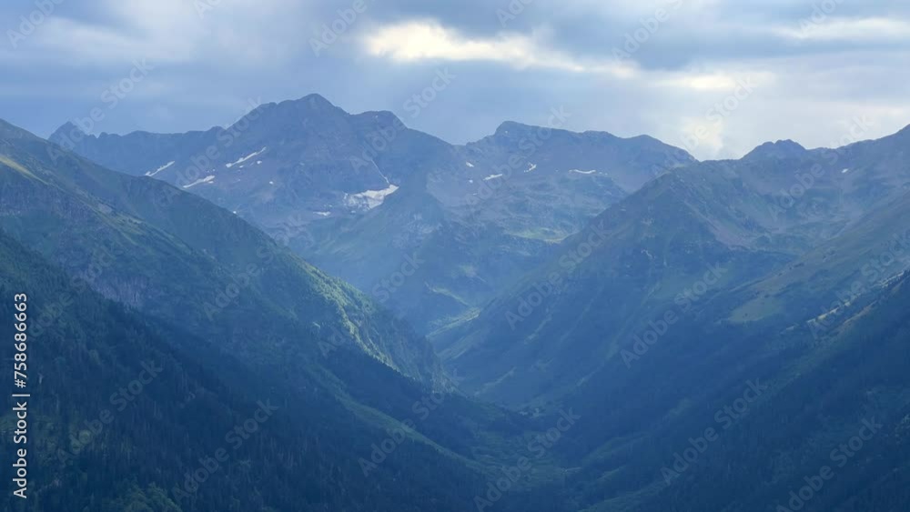 View of the mountain range near Mount Zakan. The top of the mountain node of the western part of the main ridge of the Greater Caucasus. Zakan Peak is the beginning of the Magisho mountain range. 4К View of the mountain range near Mount Zakan. The top of the mountain node of the western part of the main ridge of the Greater Caucasus. Zakan Peak is the beginning of the Magisho mountain range. 4К