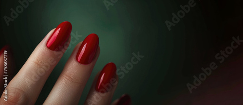 Close-up of young woman's hands with dark red manicure on nails photo