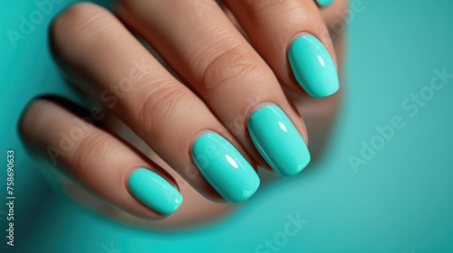 Turquoise manicure on a woman's hand. photo