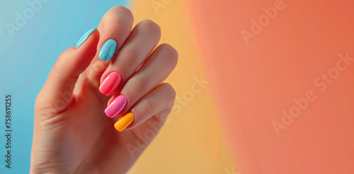 Bright multi-colored manicure on a woman's hand.