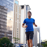 Fitness, health and man running in city training for marathon, competition or race. Exercise, wellness and male athlete with outdoor cardio workout for endurance, energy or speed in urban town