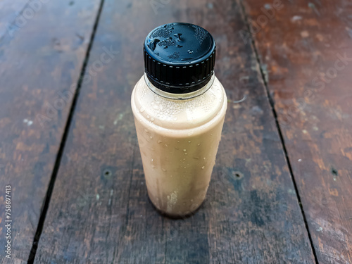 Bottle of pure cow's milk with added chocolate flavor photo