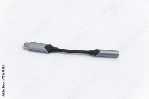 An adapter for a USB to 3.5mm type c headphone cable on a smartphone. 3.5 audio cable for phone on android mm on a white background. View from above 