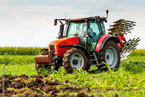 Agricultural tractor tilling fertile soil  readying the field for sowing