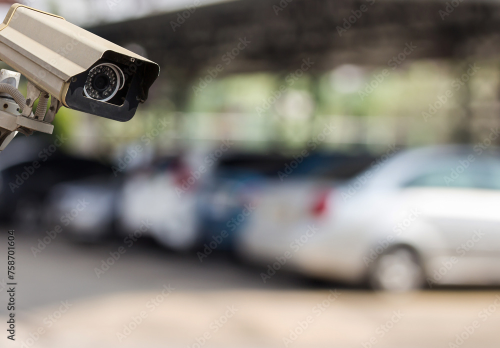 CCTV security camera on blur car parking