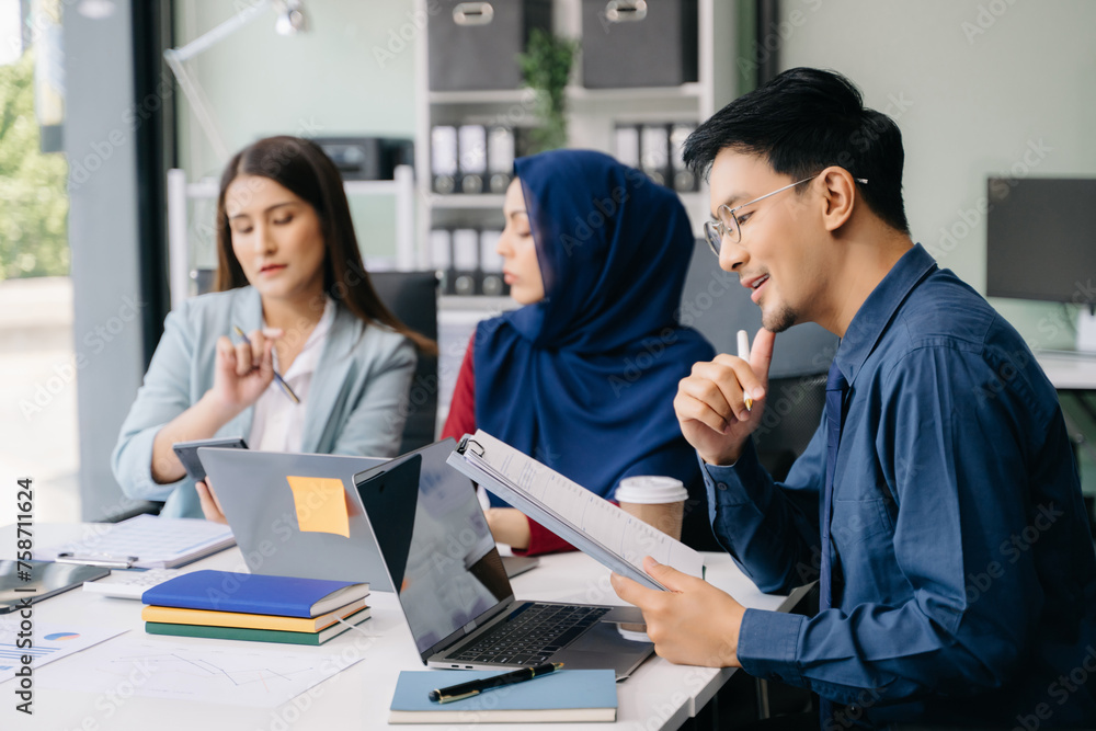 Multiracial group of young creative people in smart casual wear discussing business brainstorming meeting ideas design project. Multiracial group of young creative people in smart casual wear discussing business brainstorming meeting ideas design project.