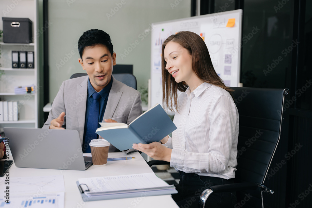 Fototapeta premium Businesswoman and man discuss investment project working and planning strategy with tablet laptop computer