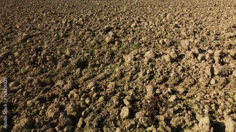 Overhead drone shot of a dried out crop filed, tilting up to reveal some more Austrian crop fields Overhead drone shot of a dried out crop filed, tilting up to reveal some more Austrian crop fields