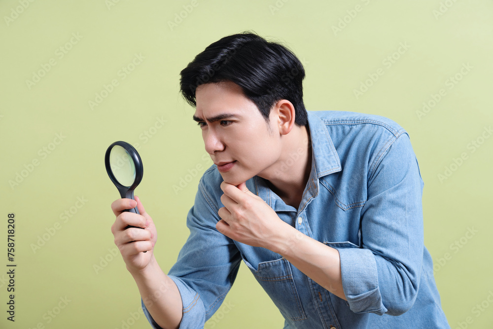 Photo of young Asian man on green background Photo of young Asian man on green background