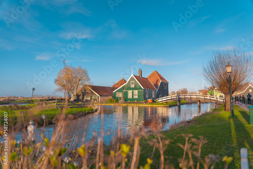 Traditional wooden houses specific to the Dutch style. Brightly colored ancient houses in the village of Zaanse Schans