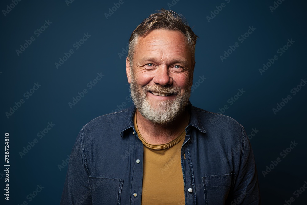 Handsome middle age man with beard and mustache on blue background Handsome middle age man with beard and mustache on blue background