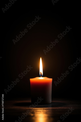 Single candle with bright flame on wooden surface