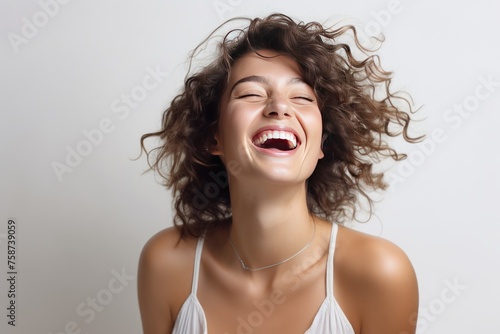 Smiling brunette woman portrait with fashionable hair and radiant expression in studio