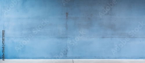 Blank concrete wall against a blue cement background.