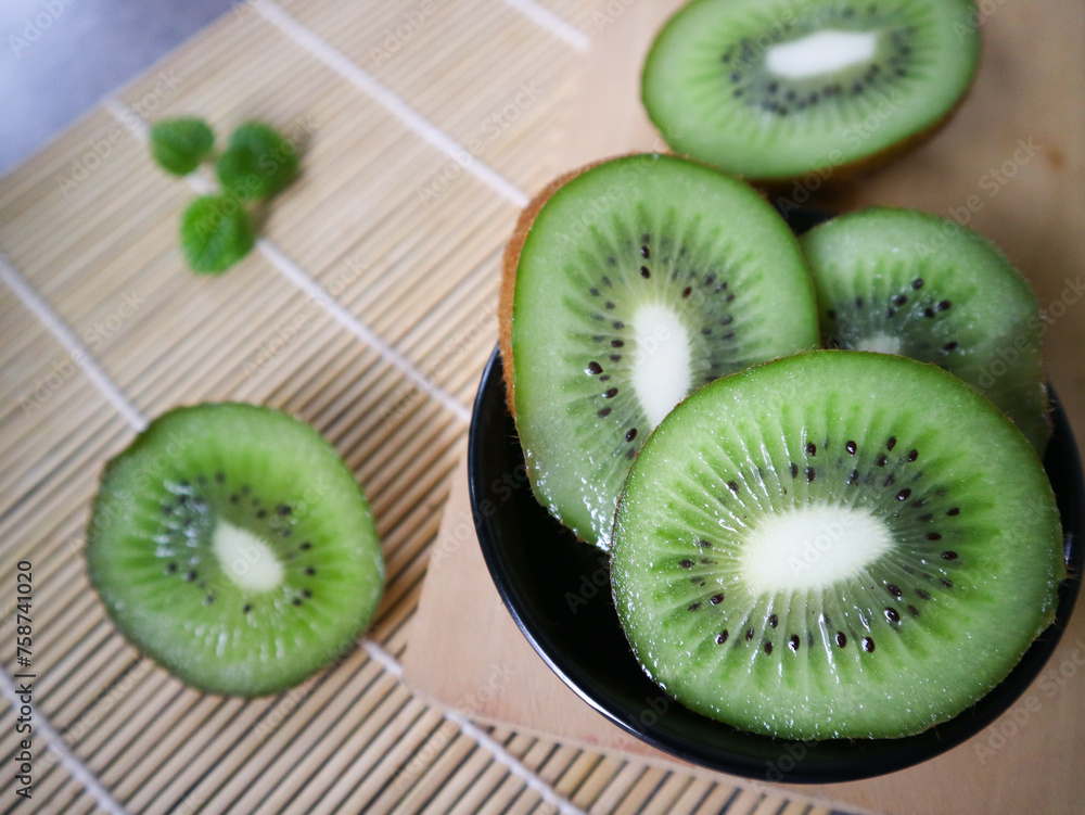 Kiwi fruit on wooden background.
Kiwi fruit on wooden background.