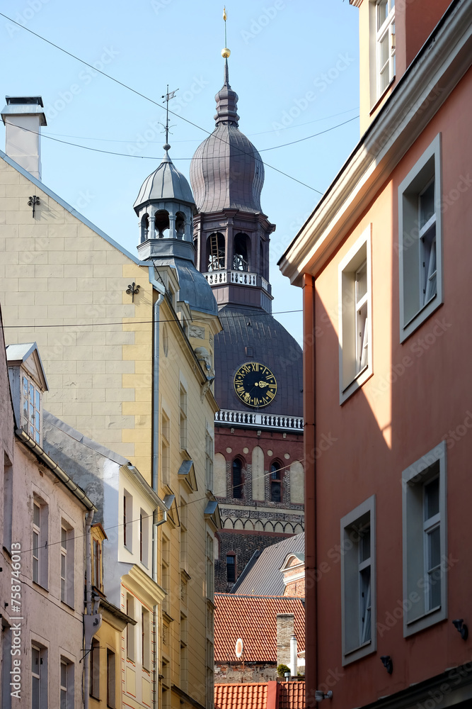 View to cupola Dome Cathedral from dense standing houses of old town Riga