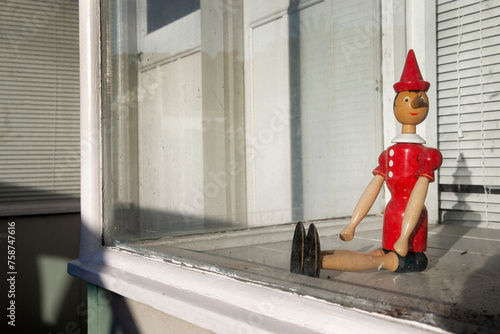 Wooden doll. Pinocchio in window at Kilbirnie Wellington New Zealand. photo