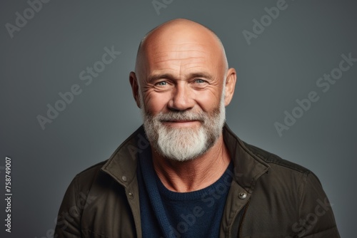Portrait of a senior man with grey hair and beard. Studio shot.
