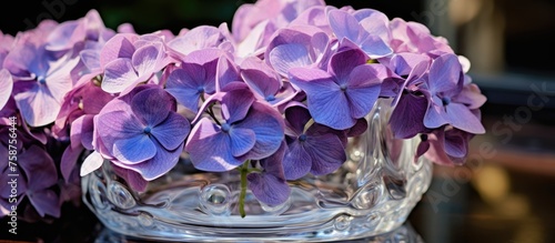Close-up of violet hydrangea in an aged glass container. photo