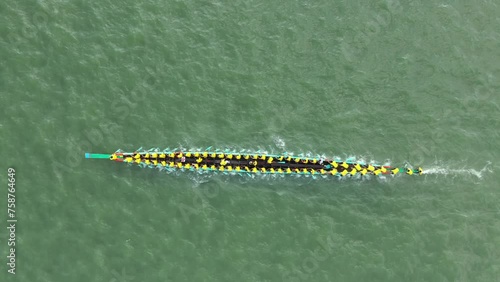 Aerial view of a long canoe for sport activities crossing Meghna river branch near Daudkandi township, Chittagong, Bangladesh. photo