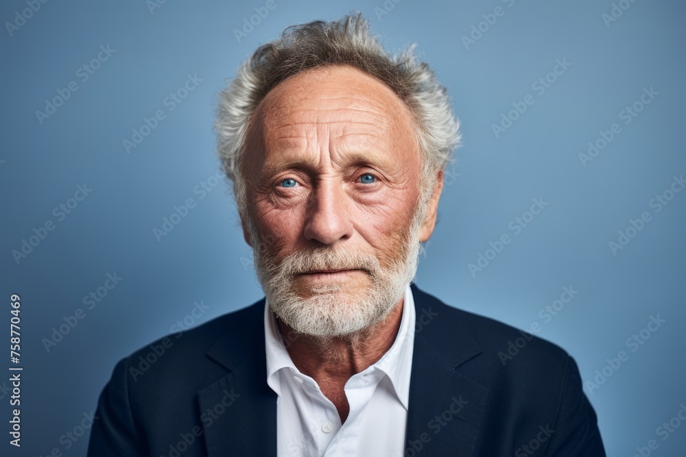 Portrait of senior man with grey hair and beard. Isolated on blue background. Portrait of senior man with grey hair and beard. Isolated on blue background.