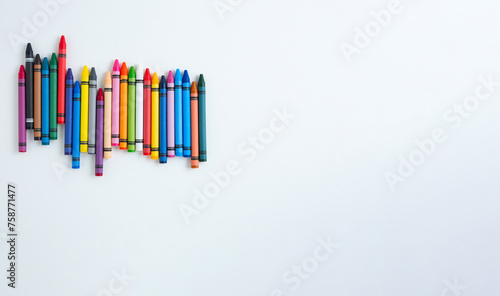 Children's multi-colored wax crayons for drawing on a white album sheet