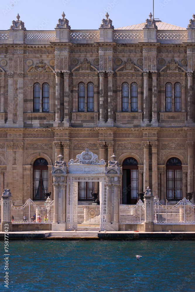 View from the water of the Bosphorus Strait to ancient palaces and buildings. Public place on the street of Istanbul, Türkiye.