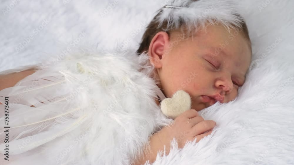baby with angel wings sleeps on the bed. selective focus. baby with angel wings sleeps on the bed. selective focus.