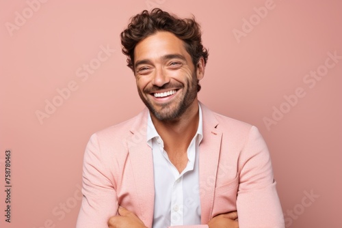 Portrait of a happy young man in a pink jacket on a pink background © Loli