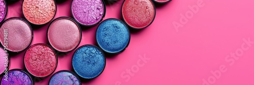 lots of shining multi-colored eye shadow, top view, pink background, horizontal banner for make-up, poster for beauty and cosmetology, free space for text