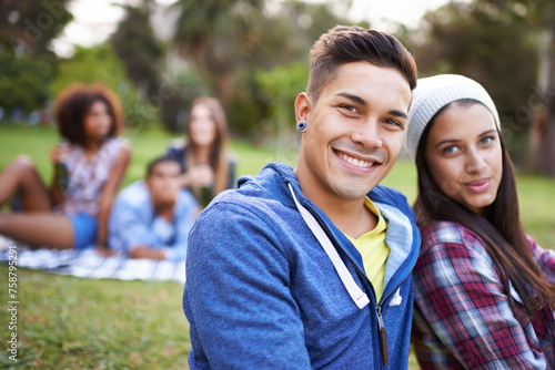 Couple, smile and portrait with love in park with bonding and fun on campus outdoor. Students, grass and happy together in a university garden on break on a picnic with college people with hipster