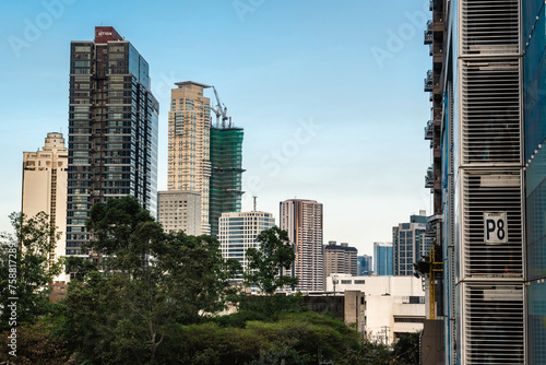 Makati, Philippines - Mar 02, 2024: Luxury condominiums along Washington Sycip Park in Legaspi Village during the late afternoon. photo