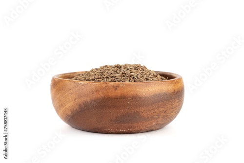 Wooden bowl filled with dried cumin or zara seeds on a white background.