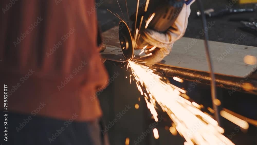 Man works circular saw. Sparks fly from hot metal. Man hard worked over the steel. Close-up slow motion shot in garage or workshop Man works circular saw. Sparks fly from hot metal. Man hard worked over the steel. Close-up slow motion shot in garage or workshop
