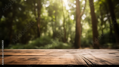 Empty wooden table in front of forest background photo