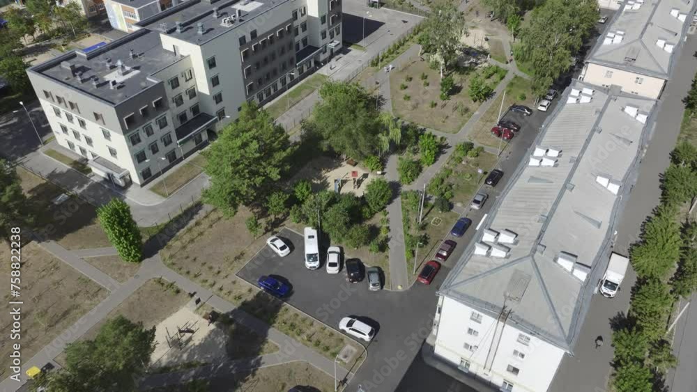 Rows of apartment buildings line streets in city center. Residents of multistory buildings enjoy access to wide range of amenities Rows of apartment buildings line streets in city center. Residents of multistory buildings enjoy access to wide range of amenities