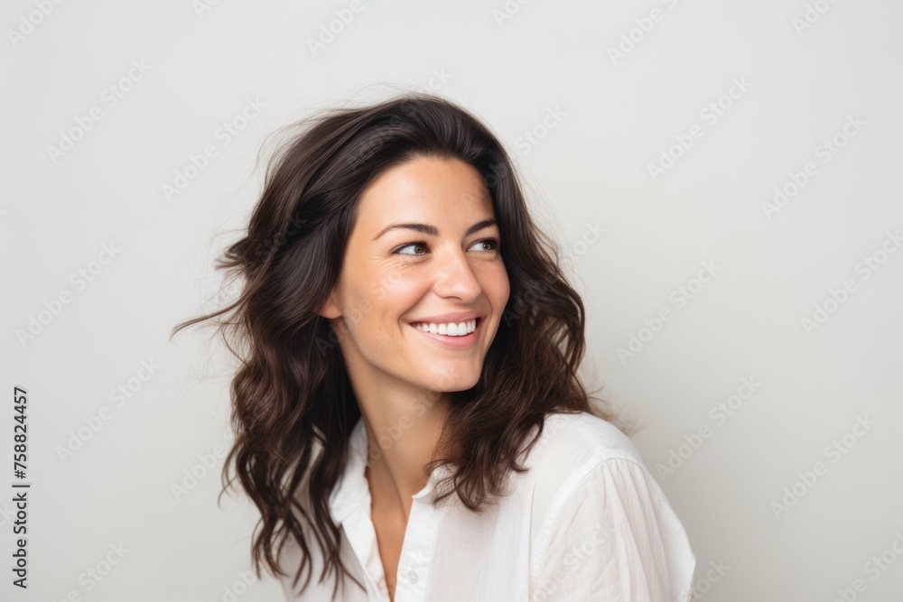 Portrait of a beautiful young woman smiling and looking at the camera Portrait of a beautiful young woman smiling and looking at the camera