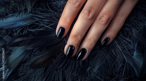 Glamour woman hand with luxury black color nail polish manicure on fingers, touching black feathers, close up for cosmetic advertising, feminine product, romantic atmosphere use