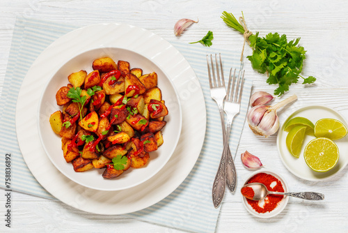 fried spanish potatoes with paprika sauce in bowl © myviewpoint