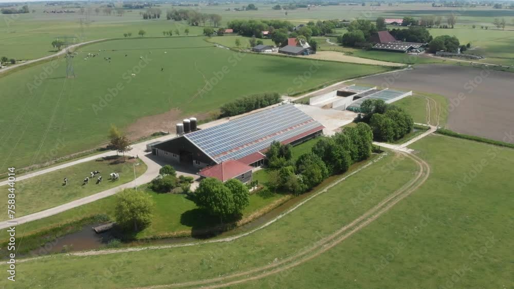 Aerial view of farm shed with solar panels on roof during sunny day, Netherlands Aerial view of farm shed with solar panels on roof during sunny day, Netherlands