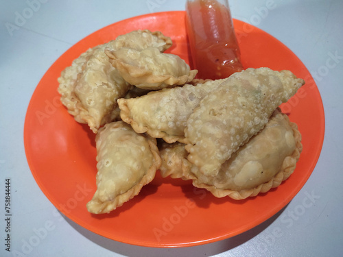 A platter of jalangkote (pastry) cakes is ready to be enjoyed. Jalangkote cakes are commonly served as appetizers during the Ramadan fasting month. photo