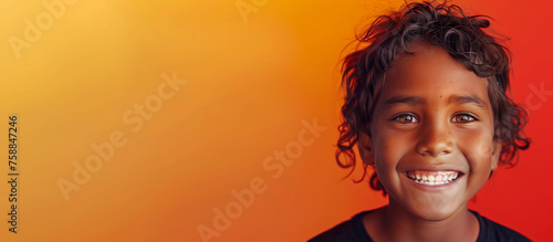 One happy 10 yr old boy student Indigenous Aboriginal Australian kid curls hair black skin diverse positive  portrait isolated first nation dreamtime child education reconciliation equality copy space photo